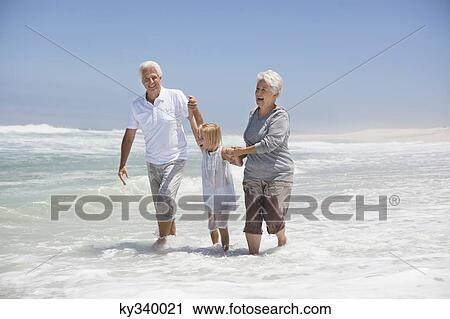 Granddaughter enjoying with grandparents on beach View Large Photo Image Stock Image - Granddaughter enjoying with grandparents on beach. Fotosearch