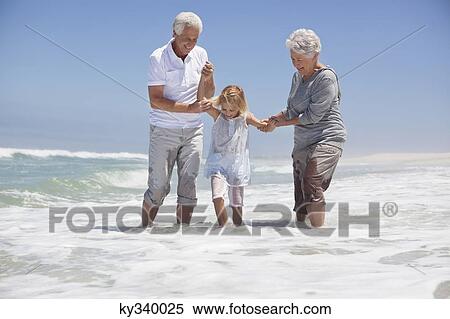 Granddaughter enjoying with grandparents on beach View Large Photo Image Stock Photography - Granddaughter enjoying with grandparents on beach. Fotosearch