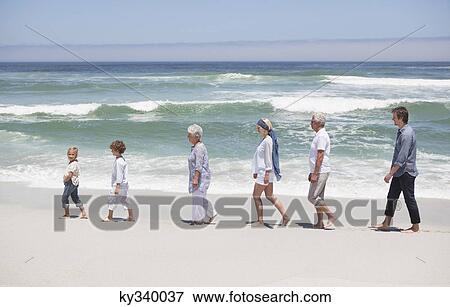 People at beach walking in row with kids View Large Photo Image Stock Photo - People at beach walking in row with kids . Fotosearch