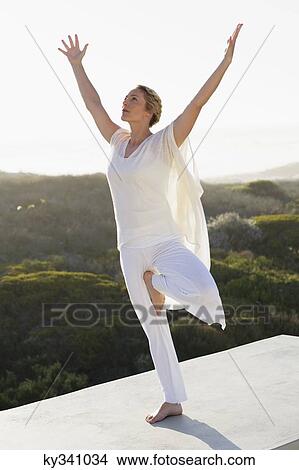 Mid adult woman practicing yoga View Large Photo Image Picture - Mid adult woman practicing yoga. Fotosearch