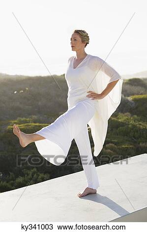 Mid adult woman practicing yoga View Large Photo Image Stock Image - Mid adult woman practicing yoga. Fotosearch