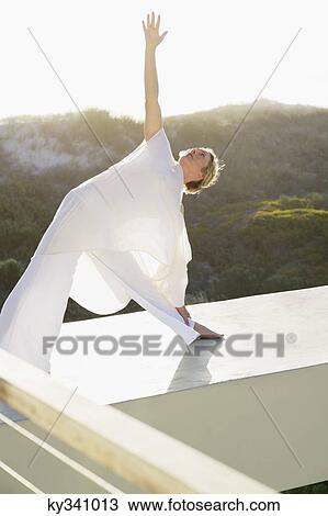 Mid adult woman stretching her arms View Large Photo Image Stock Image - Mid adult woman stretching her arms. Fotosearch
