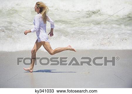 Side profile of a beautiful woman running on the beach View Large Photo Image Stock Image - Side profile of a beautiful woman running on the beach. Fotosearch