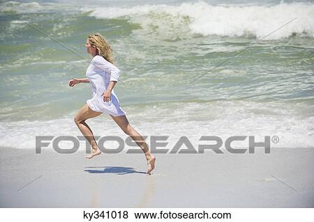 Side profile of a beautiful woman running on the beach View Large Photo Image Stock Photo - Side profile of a beautiful woman running on the beach. Fotosearch