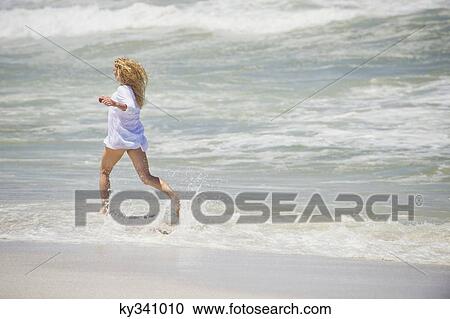 Side profile of a woman running on the beach View Large Photo Image Stock Image - Side profile of a woman running on the beach. Fotosearch
