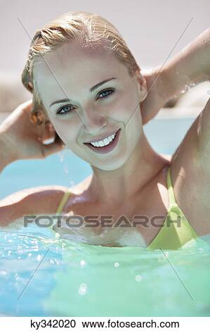 Beautiful woman smiling in pool View Large Photo Image Stock Image - Beautiful woman smiling in pool. Fotosearch