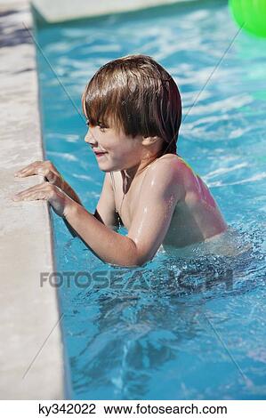 Boy smiling in a swimming pool View Large Photo Image Stock Image - Boy smiling in a swimming pool. Fotosearch