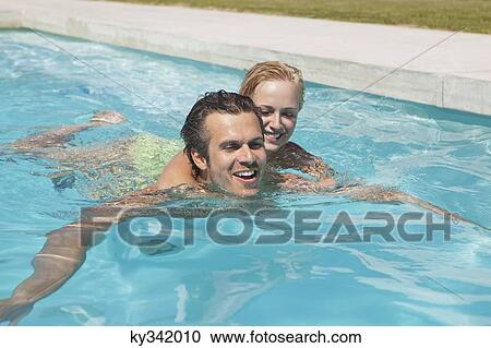 Stock Image - Couple having fun in swimming pool. Fotosearch