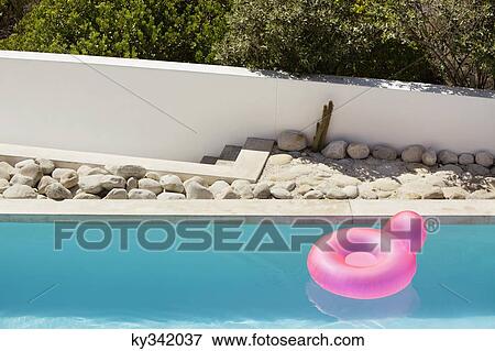 Inflatable ring floating on water in pool View Large Photo Image Stock Photo - Inflatable ring floating on water in pool. Fotosearch