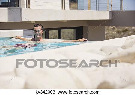 Portrait of a man resting in a swimming pool View Large Photo Image Stock Image - Portrait of a man resting in a swimming pool. Fotosearch