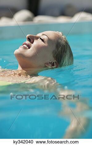 Woman relaxing in swimming pool View Large Photo Image Stock Image - Woman relaxing in swimming pool. Fotosearch