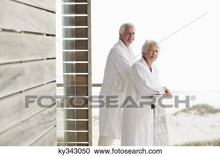 Senior couple standing at a balcony View Large Photo Image Stock Image - Senior couple standing at a balcony. Fotosearch