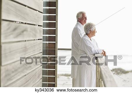 Senior couple standing at a balcony View Large Photo Image Stock Photograph - Senior couple standing at a balcony. Fotosearch