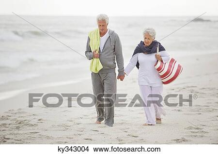 Senior couple walking on the beach View Large Photo Image Picture - Senior couple walking on the beach. Fotosearch