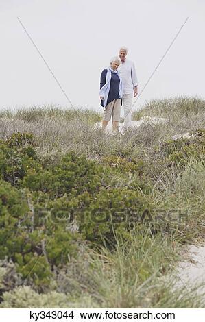 Senior couple walking on the beach View Large Photo Image Picture - Senior couple walking on the beach. Fotosearch