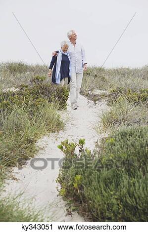 Senior couple walking on the beach View Large Photo Image Stock Image - Senior couple walking on the beach. Fotosearch
