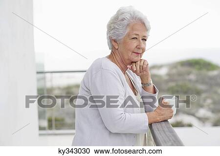 Senior woman holding a coffee cup View Large Photo Image Stock Image - Senior woman holding a coffee cup. Fotosearch
