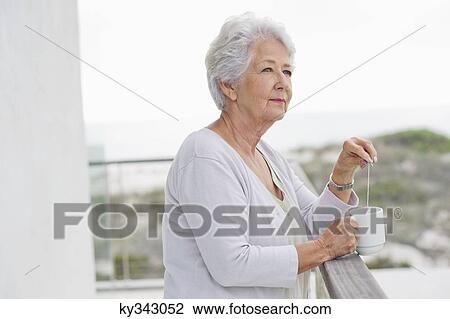 Senior woman holding a coffee cup View Large Photo Image Stock Image - Senior woman holding a coffee cup. Fotosearch