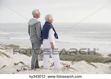 Side profile of a senior couple looking at the sea View Large Photo Image Stock Image - Side profile of a senior couple looking at the sea. Fotosearch