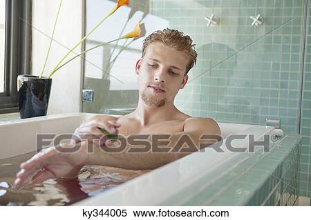Man applying soap on his body View Large Photo Image Stock Photography - Man applying soap on his body. Fotosearch