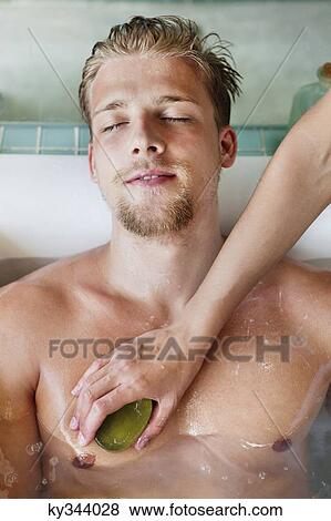 Man getting bath in a bathtub View Large Photo Image Stock Photo - Man getting bath in a bathtub. Fotosearch