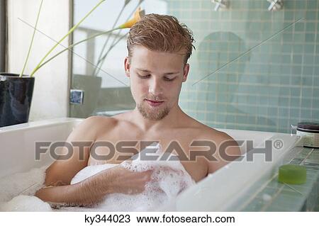 Man having bubble bath in a bathtub View Large Photo Image Stock Image - Man having bubble bath in a bathtub. Fotosearch