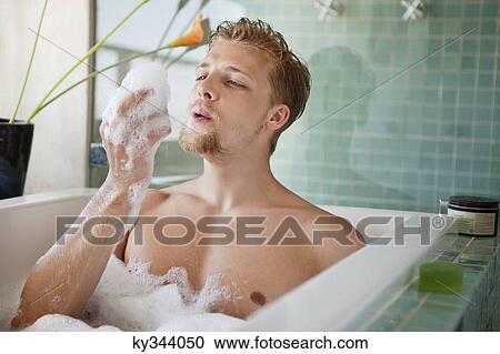 Man having bubble bath in a bathtub View Large Photo Image Stock Image - Man having bubble bath in a bathtub. Fotosearch
