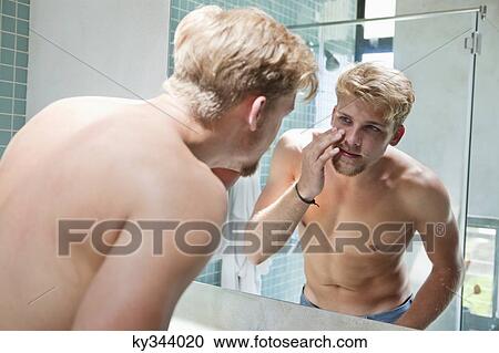 Man looking at himself in mirror View Large Photo Image Stock Image - Man looking at himself in mirror. Fotosearch