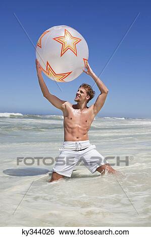 Man playing with beach ball View Large Photo Image Stock Photograph - Man playing with beach ball. Fotosearch