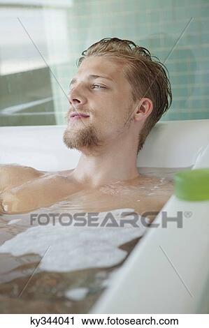 Man relaxing in a bathtub View Large Photo Image Stock Image - Man relaxing in a bathtub. Fotosearch