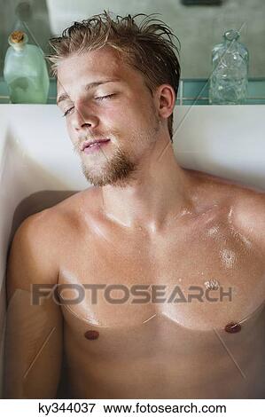 Man relaxing in a bathtub View Large Photo Image Stock Photo - Man relaxing in a bathtub. Fotosearch