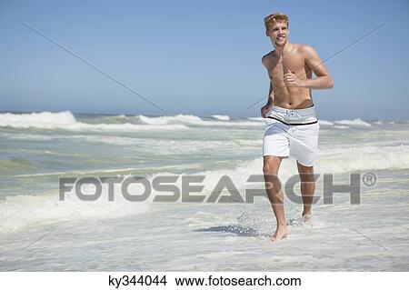 Man running on the beach View Large Photo Image Picture - Man running on the beach. Fotosearch