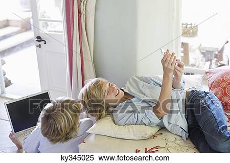 Children using electronic gadgets at home View Large Photo Image Stock Photography - Children using electronic gadgets at home. Fotosearch