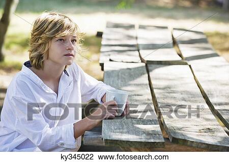 Contemplative little boy drinking tea outdoors View Large Photo Image Stock Image - Contemplative little boy drinking tea outdoors. Fotosearch