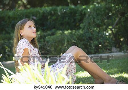 Contemplative little girl looking up in garden View Large Photo Image Stock Image - Contemplative little girl looking up in garden. Fotosearch