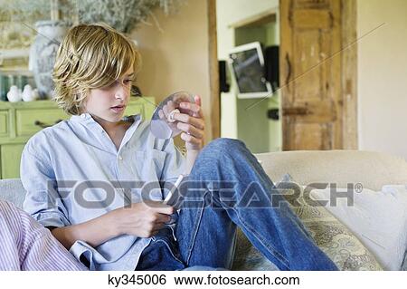 Cute little boy looking at compact disc View Large Photo Image Stock Photograph - Cute little boy looking at compact disc. Fotosearch