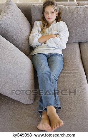 High angle view of a girl lying on a couch View Large Photo Image Stock Photo - High angle view of a girl lying on a couch. Fotosearch