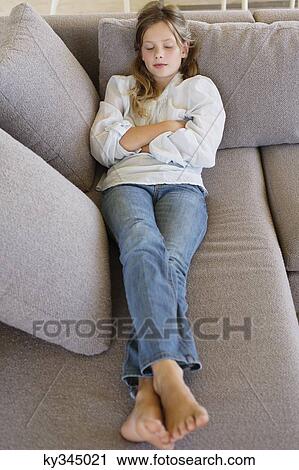 High angle view of a girl sleeping on a couch View Large Photo Image Stock Image - High angle view of a girl sleeping on a couch. Fotosearch