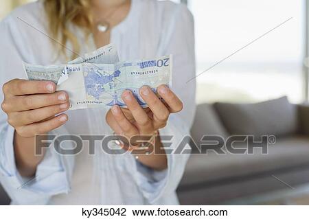 Mid section view of a girl holding paper currency View Large Photo Image Stock Image - Mid section view of a girl holding paper currency. Fotosearch