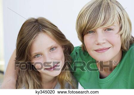 Portrait of a teenage boy smiling with his sister View Large Photo Image Stock Image - Portrait of a teenage boy smiling with his sister. Fotosearch