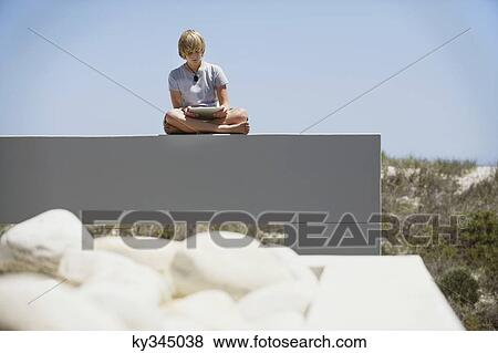 Teenage boy using a digital tablet View Large Photo Image Stock Photo - Teenage boy using a digital tablet. Fotosearch