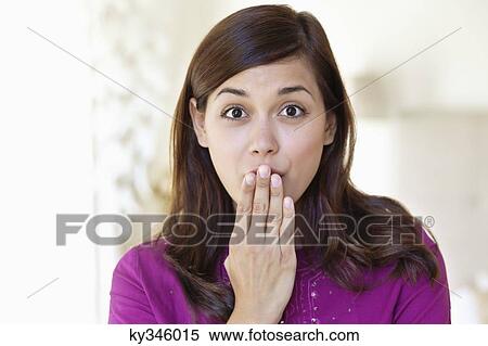 Stock Photography - Portrait of a woman looking surprised. Fotosearch