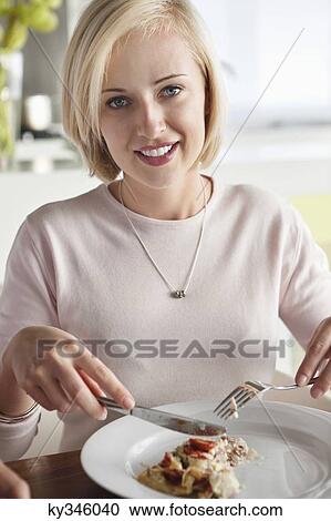 Woman having food View Large Photo Image Stock Image - Woman having food. Fotosearch
