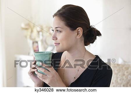 Young woman drinking tea at home View Large Photo Image Stock Photo - Young woman drinking tea at home. Fotosearch