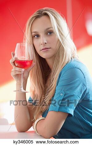 Young woman having red wine and thinking in a bar View Large Photo Image Stock Photography - Young woman having red wine and thinking in a bar. Fotosearch