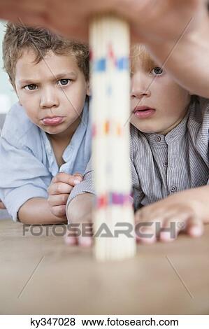 Boys looking at pick up sticks View Large Photo Image Stock Photo - Boys looking at pick up sticks. Fotosearch