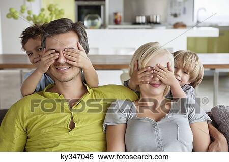 Stock Photography - Children covering parents eyes. Fotosearch