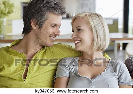 Close-up of romantic couple sitting together View Large Photo Image Stock Image - Close-up of romantic couple sitting together. Fotosearch