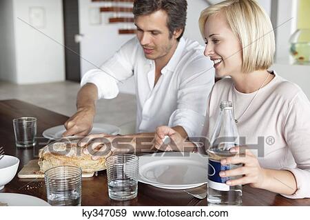 Couple having food View Large Photo Image Stock Photo - Couple having food. Fotosearch