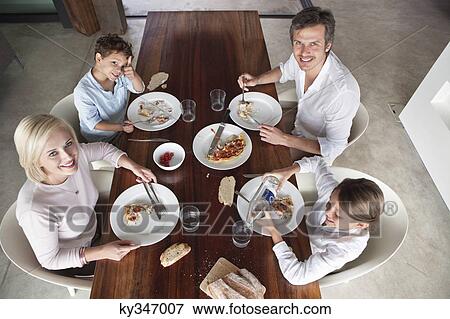 Family having food together View Large Photo Image Stock Photo - Family having food together. Fotosearch